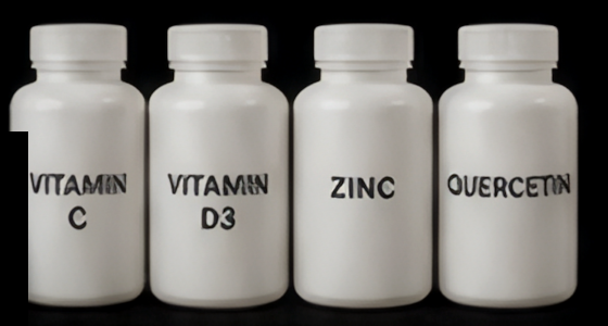 Four separate white supplement bottles labelled Vitamin C, Vitamin D3, Zinc and Quercetin